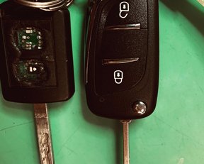two car keys with button damaged and repaired